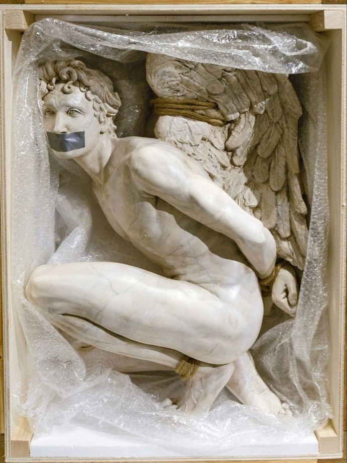 This is a statue of an angel we see him tied and helpless