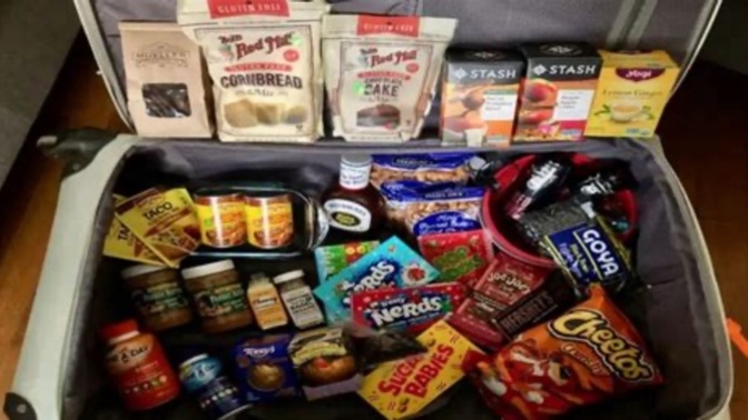 Why do immigrants pack loads of food when travelling?