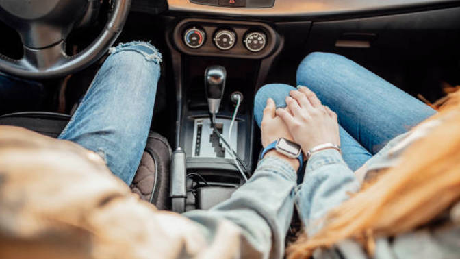 Why do some men often like to hold their partner's hand while driving?