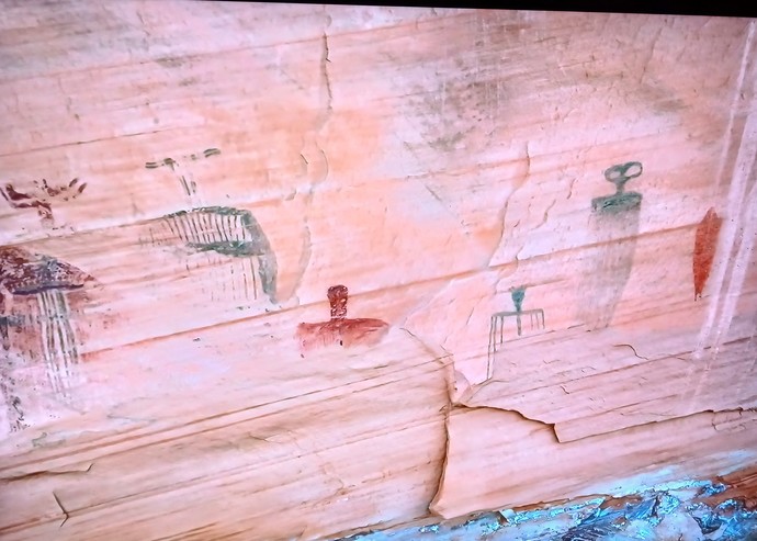 UFO on far left rising or shooting rays downward?