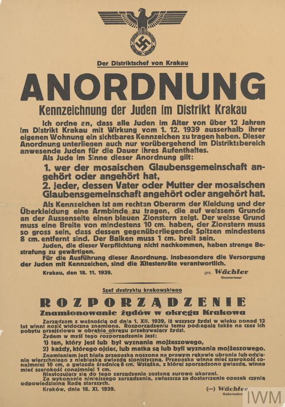 A paper poster of a NAZI decree ordering all Jews over 12 to wear a white armband with blue star of David in Krakow district.