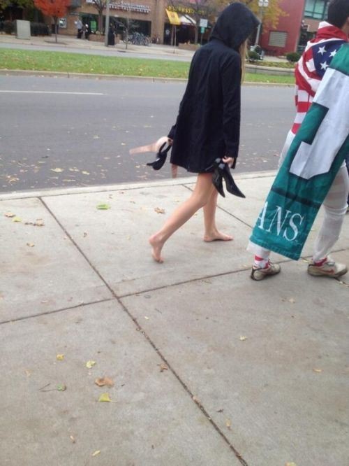 What is she holding in her left hand? Is it her bra? Is she doing the walk of shame?
