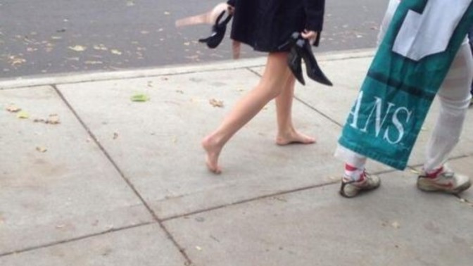 What is she holding in her left hand? Is it her bra? Is she doing the walk of shame?