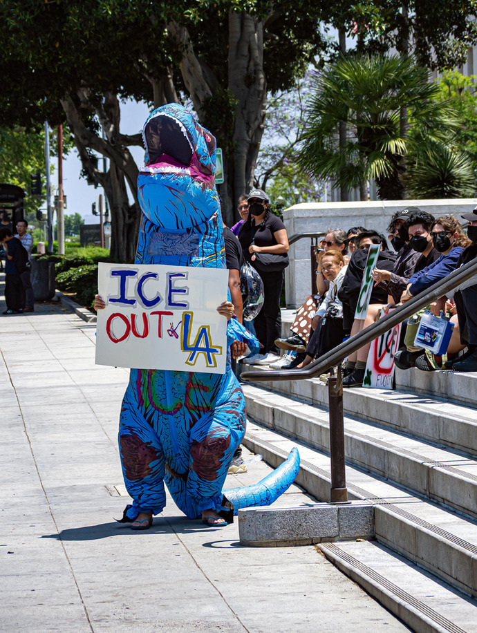 Im sure this dude in the dinosaur costume went and looted a store after this!