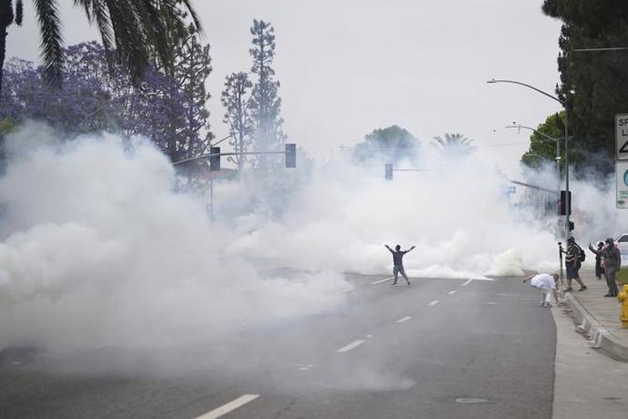 LA a lone skater pummeled with rubber bullets and smoke bombs day one. He does look terrifying.