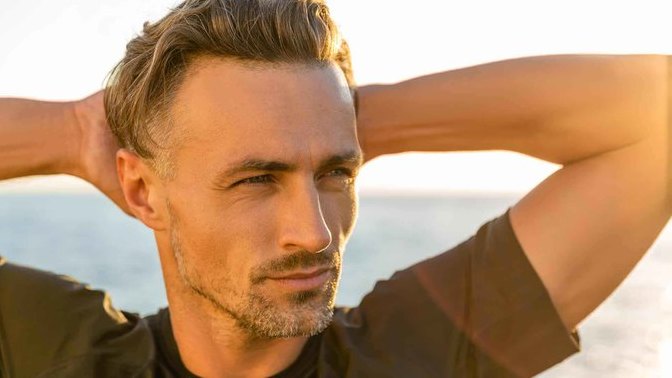 What do men do to appear more masculine in front of attractive women?