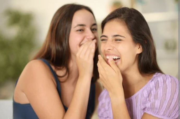 If a guy approaches a girl and she starts giggling with her friends, does that mean they’re mocking him or find him unattractive?
