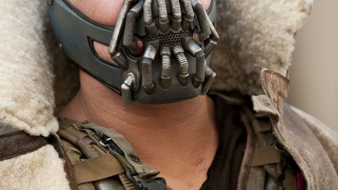Why did they make Bane so intelligent in Dark Knight Rises when he was dumb as a stump in the animated series and Arkham Asylum?
