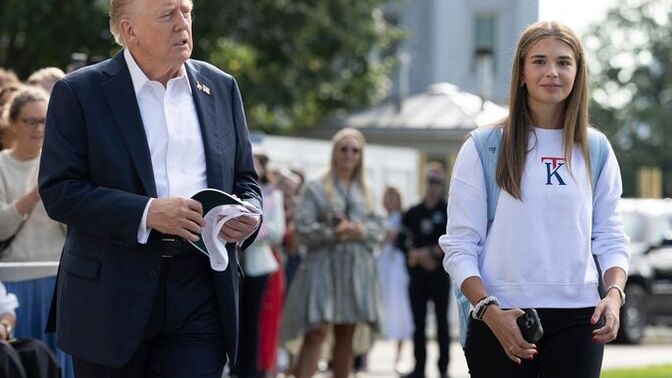 Who's this girl following Trump around at the PGA tourament?