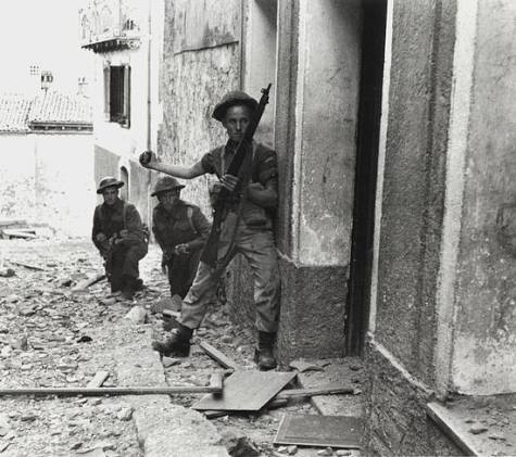 Canadian anti-fascist soldier clearing a building of fascists with a grenade in Italy (1943).