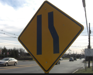 Why do some roads have two lanes that suddenly merge into one?