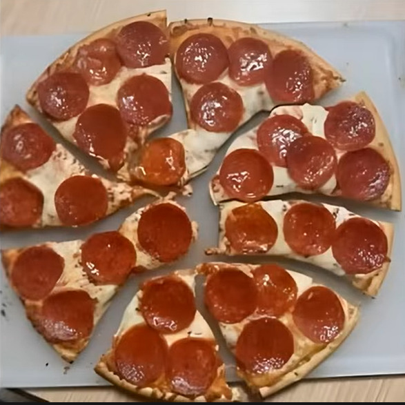 Pepperoni Pizza carefully cut so each pepperoni stays whole