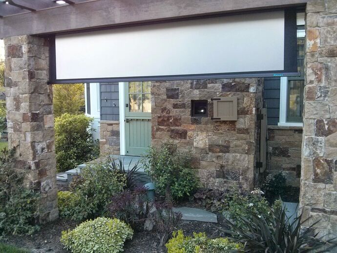 Outdoor movie area with rear-projection screen & surround sound.