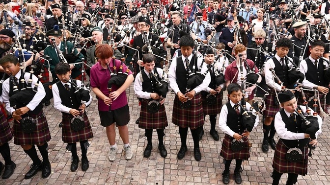 Can you guess which song 374 bagpipers played to set a new world record for the largest bagpipe ensemble?