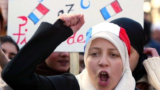 Why does France ban religious symbols in schools?