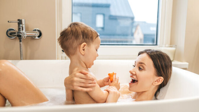 At what age should children stop taking a bath with another family member?