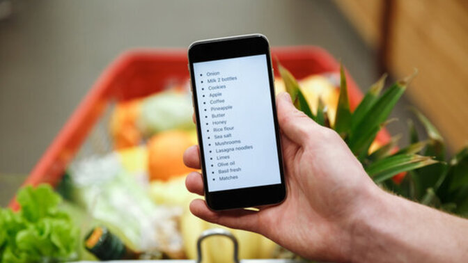 Who uses a paper list and who uses their phone to grocery shop?