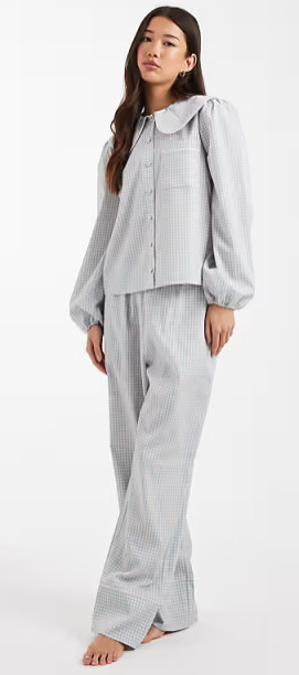 If the clothes you're wearing right now were on the woman in the image, what kind of clothes would she be wearing?