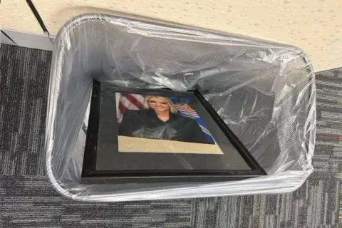 Yes that is Pam Bondi the FORMER attorney generals portrait in the garbage bin π