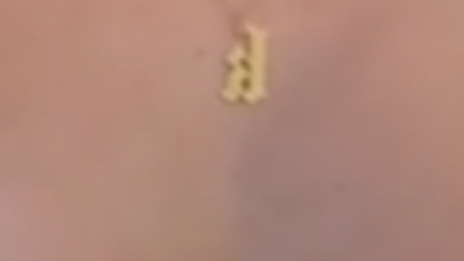 What is this symbol on her necklace and what does it mean?