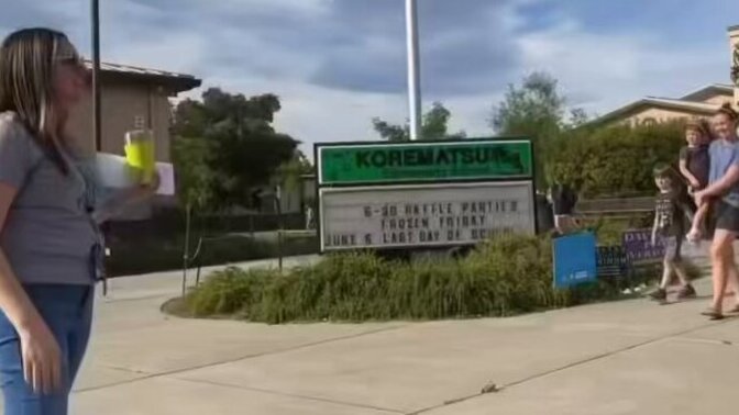 Is the phrase 'All are welcome here' on a t shirt worn by a school principal a political statement in your opinion?