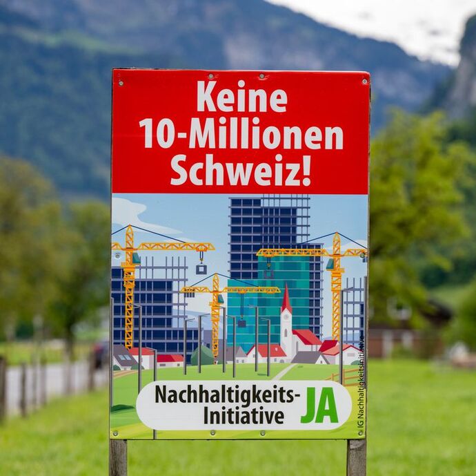 One of the posters that was used to show the idyllic swiss village towered over by huge new buildings