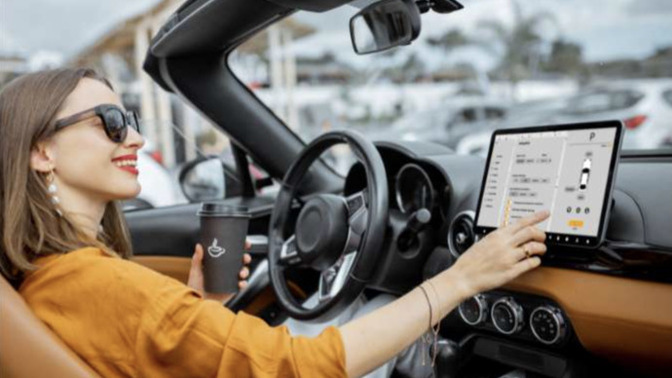 Why are large in-car touchscreens legal when phones are banned while driving?