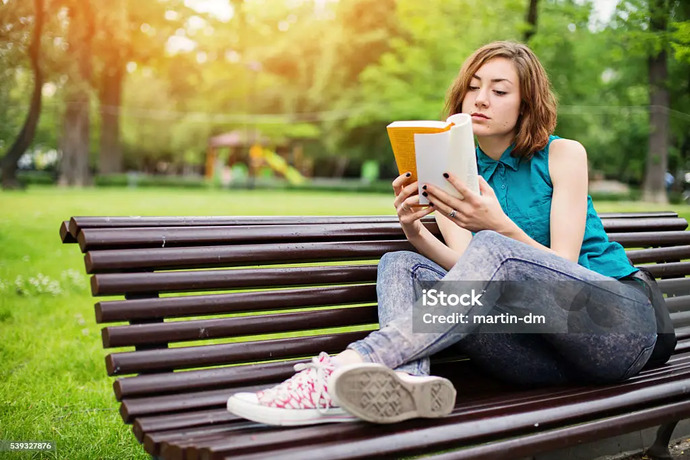 young woman reading book