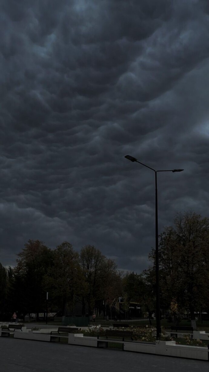 What causes nimbostratus clouds to form and produce steady rain?