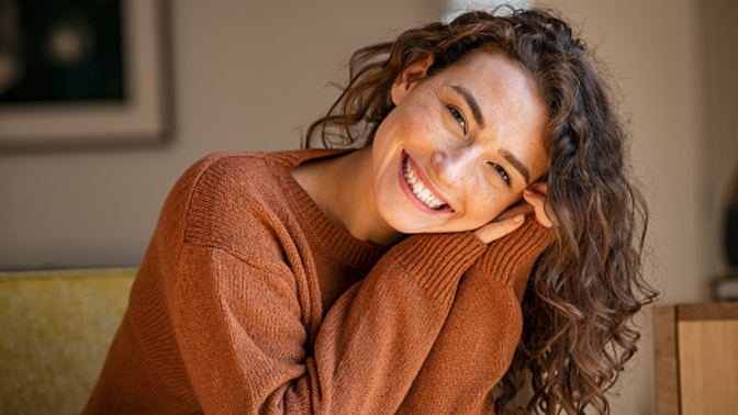 What does it mean when a girl smiles while talking?